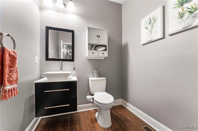 3104 1st Ave, Richmond, VA 23222 - half bath featuring wood finished floors, toilet, vanity, and baseboards