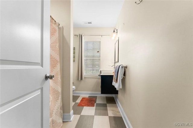 3104 1st Ave, Richmond, VA 23222 - bathroom with toilet, vanity, and baseboards