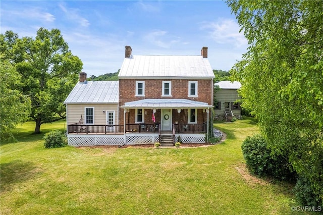 504 Springbranch Rd, Lexington, VA 24450 - view of front facade with a chimney, a front yard, brick siding, and metal roof