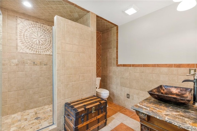 504 Springbranch Rd, Lexington, VA 24450 - bathroom with tile walls, vanity, tiled shower, toilet, and tile patterned flooring
