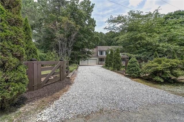15368 W Fork Dr, Glen Allen, VA 23059 - obstructed view of property featuring gravel driveway, a garage, and stucco siding