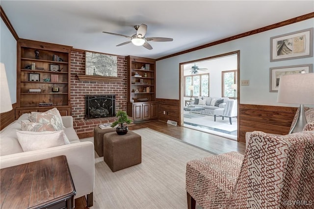 15368 W Fork Dr, Glen Allen, VA 23059 - living room featuring a ceiling fan, wood finished floors, a fireplace, built in shelves, and crown molding