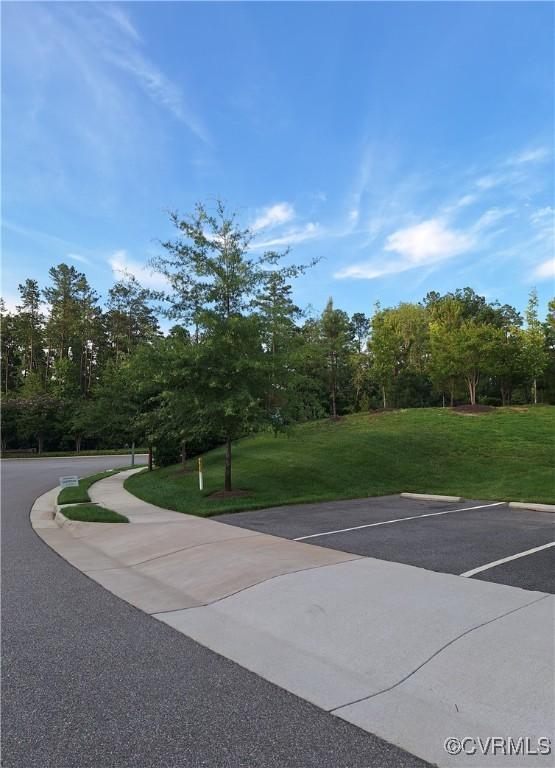 6948 Desert Candle Dr, Moseley, VA 23120 - view of home's community with a lawn and uncovered parking