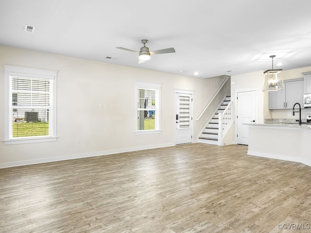 3216 Gannet Ln, Midlothian, VA 23112 - unfurnished living room featuring stairs, light wood-style floors, healthy amount of natural light, and recessed lighting