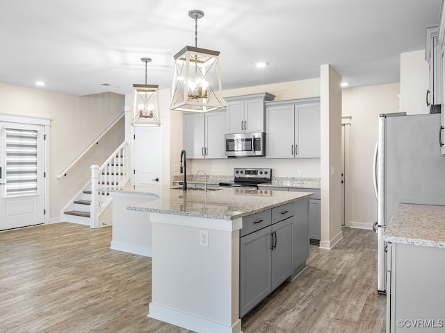 3216 Gannet Ln, Midlothian, VA 23112 - kitchen featuring appliances with stainless steel finishes, gray cabinets, a chandelier, light wood-type flooring, and recessed lighting