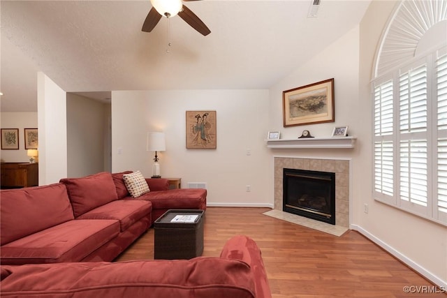 7314 Norwood Pond Pl, Chesterfield, VA 23112 - living area with a ceiling fan, wood finished floors, a tiled fireplace, and vaulted ceiling