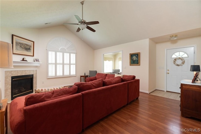 7314 Norwood Pond Pl, Chesterfield, VA 23112 - living area featuring a ceiling fan, healthy amount of natural light, a tiled fireplace, wood finished floors, and high vaulted ceiling
