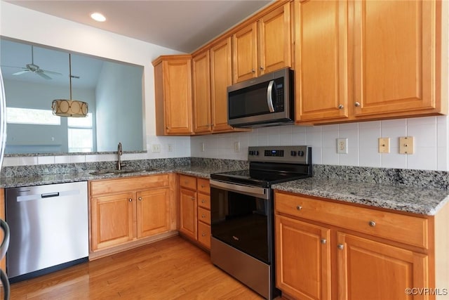 10504 Bishops Gate Dr, Glen Allen, VA 23059 - kitchen featuring stainless steel appliances, a sink, ceiling fan, light wood-type flooring, and stone counters