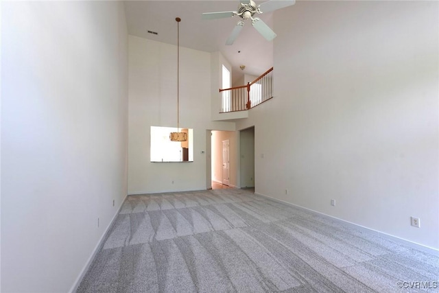 10504 Bishops Gate Dr, Glen Allen, VA 23059 - unfurnished living room with light colored carpet, a ceiling fan, a towering ceiling, and baseboards