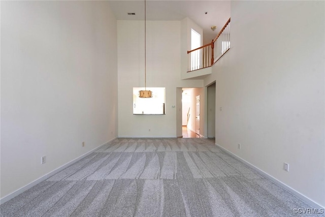 10504 Bishops Gate Dr, Glen Allen, VA 23059 - unfurnished living room with light colored carpet, a high ceiling, and baseboards