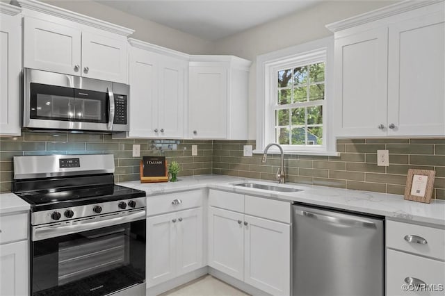 1004 W 45th St, Richmond, VA 23225 - kitchen featuring appliances with stainless steel finishes, a sink, white cabinets, and light stone counters