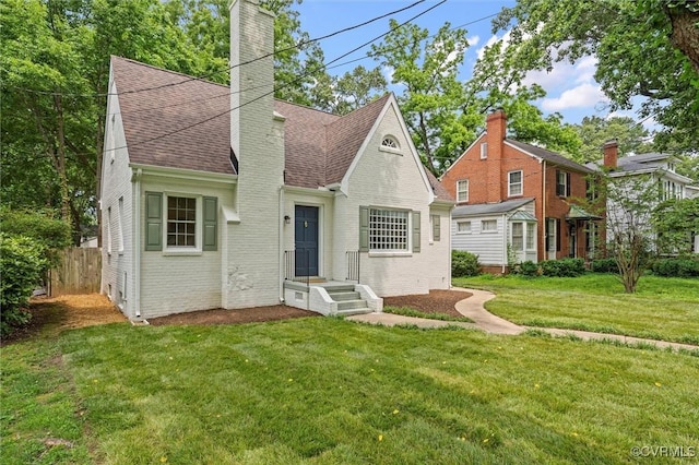 1004 W 45th St, Richmond, VA 23225 - back of property with a chimney, brick siding, and a shingled roof