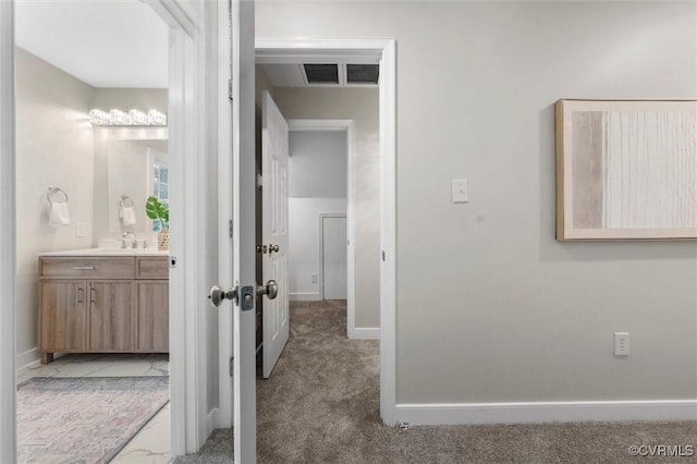 1004 W 45th St, Richmond, VA 23225 - hall with carpet flooring, a sink, and baseboards