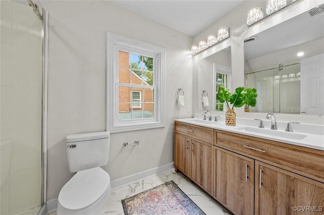 1004 W 45th St, Richmond, VA 23225 - bathroom with marble look tile flooring, baseboards, double vanity, a shower stall, and toilet