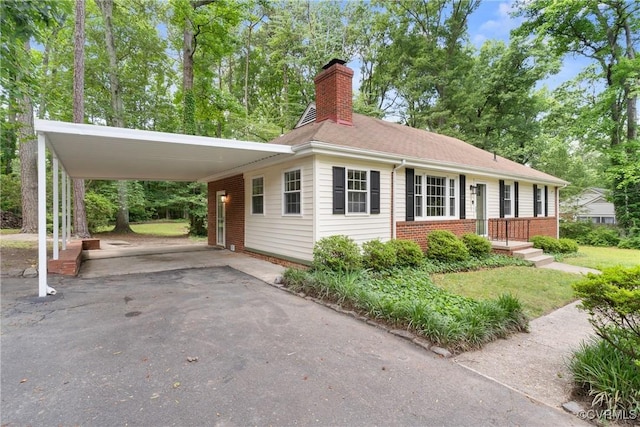 6405 Hagueman Dr, Richmond, VA 23225 - view of front facade with brick siding, a chimney, asphalt driveway, and an attached carport