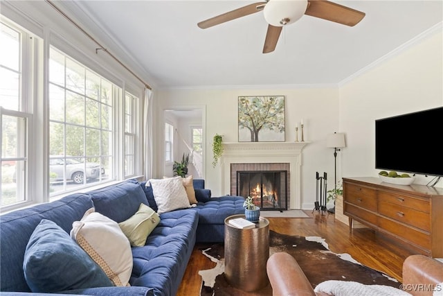 6405 Hagueman Dr, Richmond, VA 23225 - living room featuring wood finished floors, crown molding, a brick fireplace, a ceiling fan, and baseboards