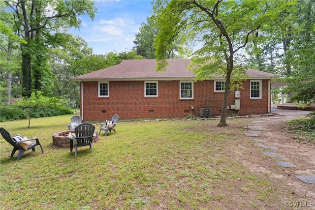 6405 Hagueman Dr, Richmond, VA 23225 - back of property with crawl space, an outdoor fire pit, a lawn, central AC, and brick siding