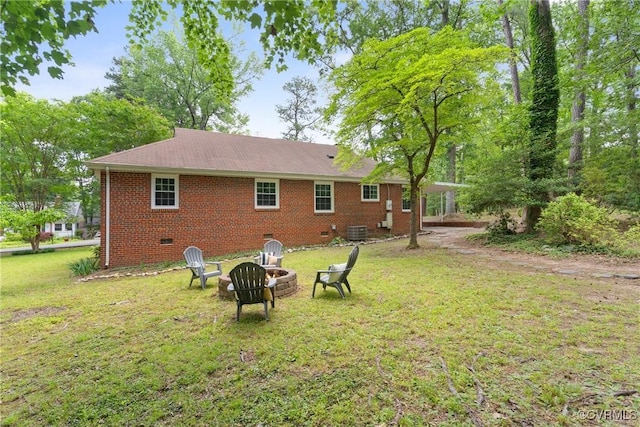 6405 Hagueman Dr, Richmond, VA 23225 - rear view of property with crawl space, an outdoor fire pit, a lawn, and central air condition unit
