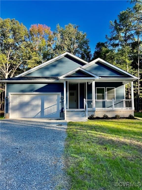 94 Dingley Rd, Montross, VA 22520 - view of front of home with an attached garage, covered porch, a front yard, and gravel driveway