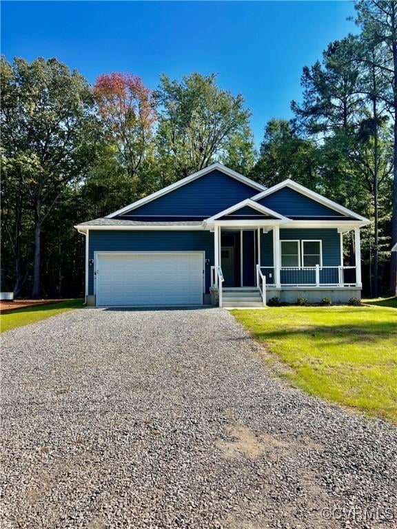 94 Dingley Rd, Montross, VA 22520 - ranch-style home featuring driveway, a garage, covered porch, and a front lawn