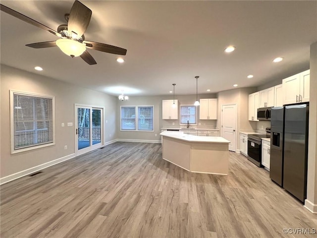 94 Dingley Rd, Montross, VA 22520 - kitchen with appliances with stainless steel finishes, light wood finished floors, white cabinetry, light countertops, and a kitchen island