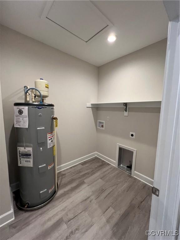 94 Dingley Rd, Montross, VA 22520 - laundry room featuring water heater, washer hookup, hookup for an electric dryer, wood finished floors, and baseboards