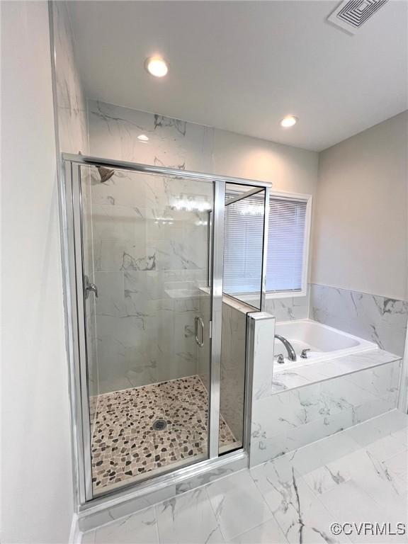 94 Dingley Rd, Montross, VA 22520 - bathroom featuring a garden tub, a marble finish shower, marble look tiles, and recessed lighting