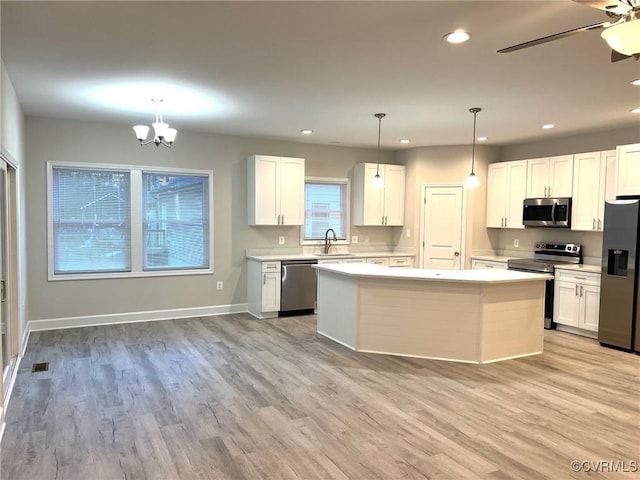 94 Dingley Rd, Montross, VA 22520 - kitchen featuring stainless steel appliances, a sink, light countertops, white cabinetry, and light wood-style flooring