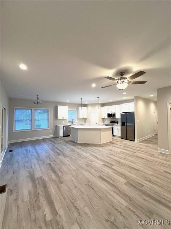 94 Dingley Rd, Montross, VA 22520 - unfurnished living room with recessed lighting, baseboards, light wood finished floors, and a chandelier