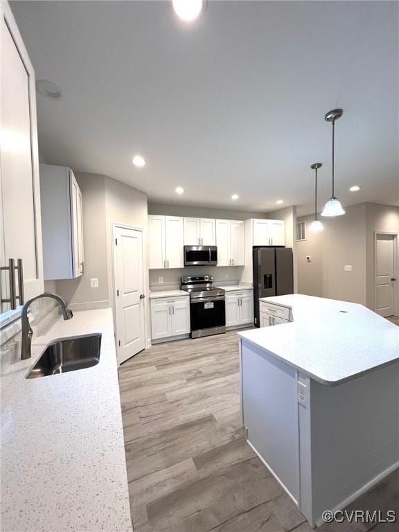 94 Dingley Rd, Montross, VA 22520 - kitchen with stainless steel appliances, a sink, recessed lighting, light countertops, and light wood-style flooring
