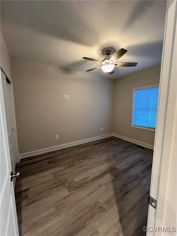 94 Dingley Rd, Montross, VA 22520 - unfurnished bedroom with dark wood-type flooring, baseboards, ceiling fan, and a textured ceiling