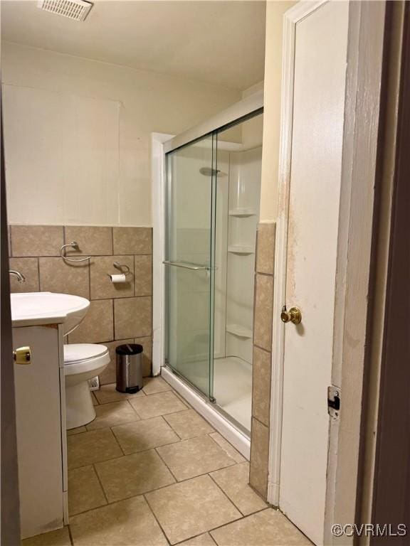 1501 Campbell Dr, Petersburg, VA 23803 - full bathroom featuring tile walls, tile patterned flooring, a stall shower, vanity, and a wainscoted wall