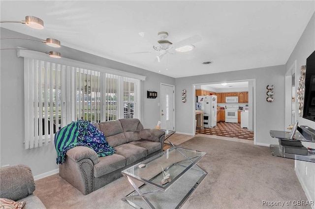 7486 Roaring Springs Rd, Gloucester, VA 23062 - living room featuring light carpet, a ceiling fan, and baseboards