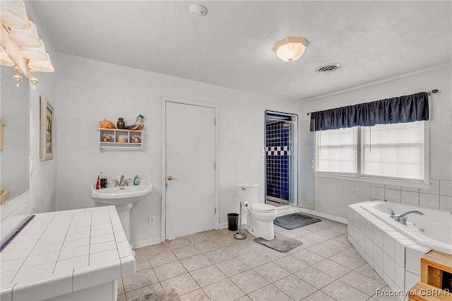 7486 Roaring Springs Rd, Gloucester, VA 23062 - bathroom featuring a whirlpool tub, toilet, and tile patterned flooring