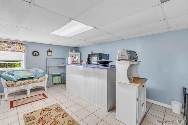 7486 Roaring Springs Rd, Gloucester, VA 23062 - kitchen featuring a drop ceiling, light tile patterned flooring, and baseboards