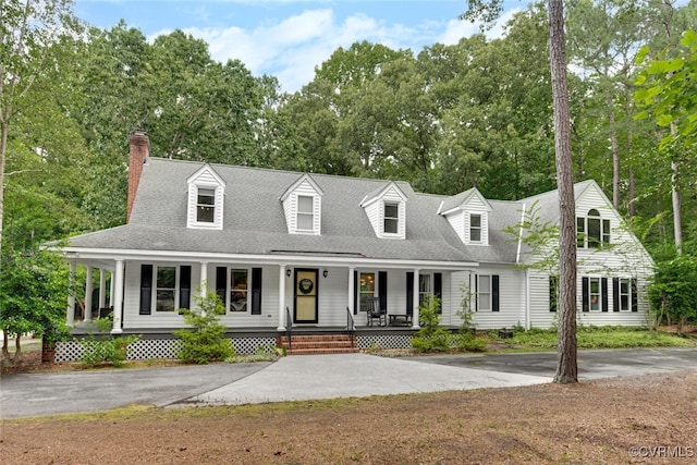 6216 Pine Slash Rd, Mechanicsville, VA 23116 - cape cod-style house with a porch, a chimney, view of wooded area, and a shingled roof