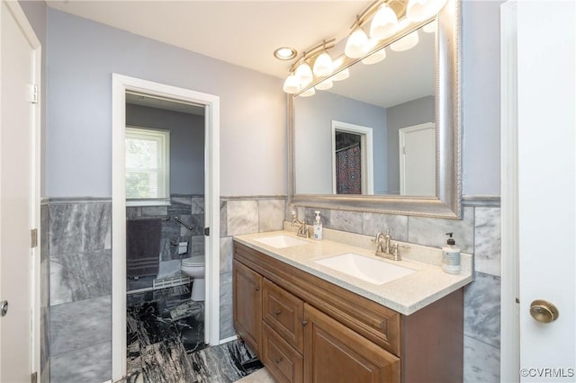 406 Windmere Dr, Colonial Heights, VA 23834 - bathroom featuring tile walls, double vanity, marble finish floors, and wainscoting