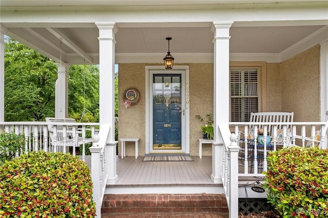1520 Bellevue Ave, Richmond, VA 23227 - view of exterior entry with a porch and stucco siding
