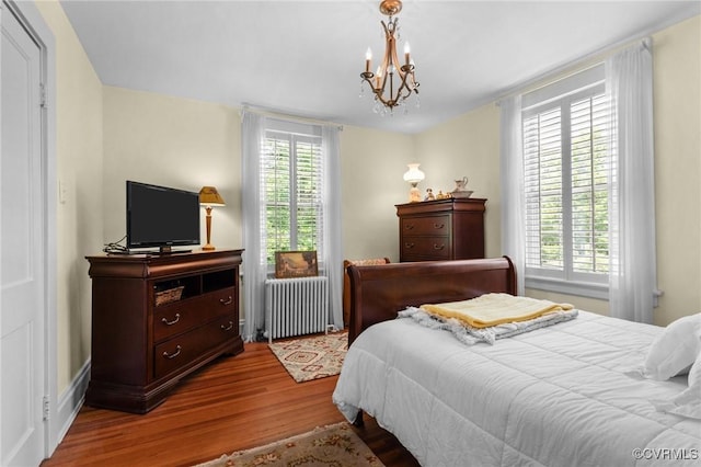 1520 Bellevue Ave, Richmond, VA 23227 - bedroom with radiator, wood finished floors, and a chandelier