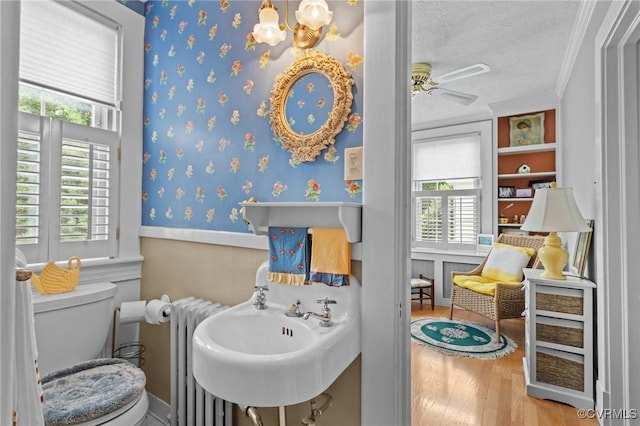 1520 Bellevue Ave, Richmond, VA 23227 - bathroom with radiator, wood finished floors, a textured ceiling, a wainscoted wall, and ornamental molding