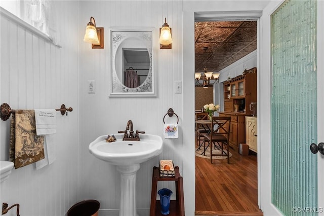 1520 Bellevue Ave, Richmond, VA 23227 - bathroom with wood finished floors, an ornate ceiling, and a chandelier