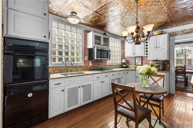 1520 Bellevue Ave, Richmond, VA 23227 - kitchen with black appliances, an ornate ceiling, healthy amount of natural light, and dark wood-style flooring