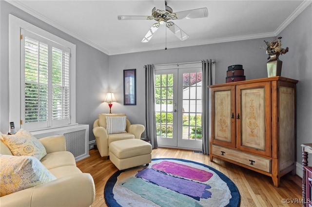 1520 Bellevue Ave, Richmond, VA 23227 - living area with light wood-type flooring, radiator heating unit, a ceiling fan, crown molding, and french doors