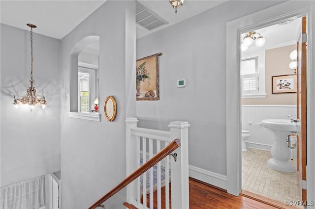 1520 Bellevue Ave, Richmond, VA 23227 - hall with an upstairs landing, arched walkways, a wainscoted wall, and wood finished floors
