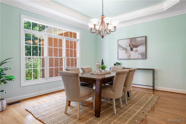 2017 Valley Springs Ct, Powhatan, VA 23139 - dining room featuring a chandelier, wood finished floors, a raised ceiling, and ornamental molding