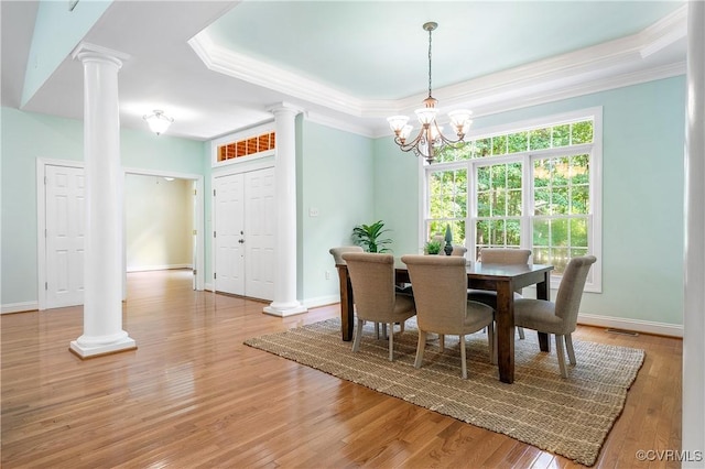 2017 Valley Springs Ct, Powhatan, VA 23139 - dining space with ornate columns, a tray ceiling, crown molding, a chandelier, and light wood finished floors