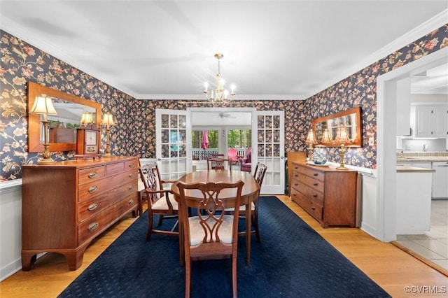 13211 Powderham Ln, Midlothian, VA 23113 - dining area featuring wallpapered walls, crown molding, light wood-style floors, a chandelier, and a wainscoted wall