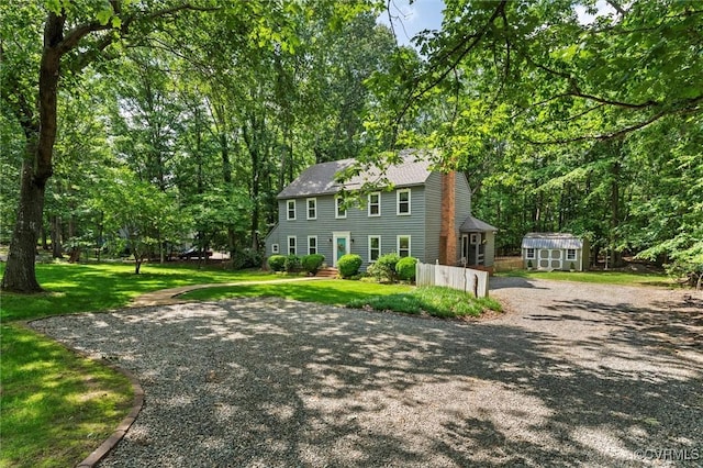 13211 Powderham Ln, Midlothian, VA 23113 - colonial home featuring a front lawn, roof with shingles, and gravel driveway