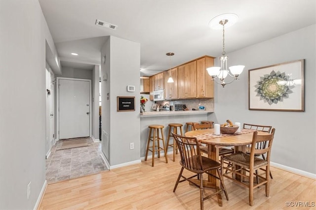 2990 Woodbridge Crossing Dr, Midlothian, VA 23112 - dining space featuring light wood finished floors, a chandelier, and recessed lighting