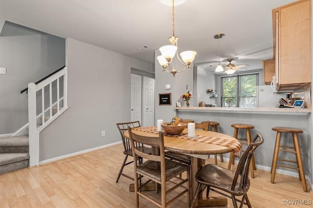 2990 Woodbridge Crossing Dr, Midlothian, VA 23112 - dining area with light wood-style floors, stairs, a ceiling fan, and a chandelier